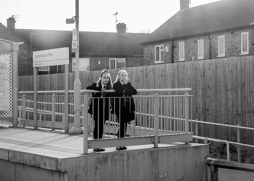 two children at a tram stop