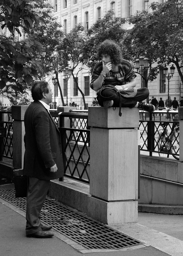 two man talking on a street