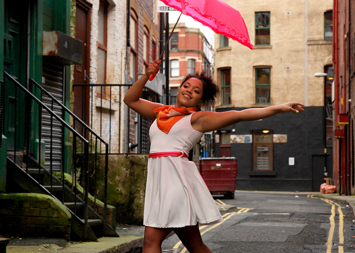 a woman dancing on a street